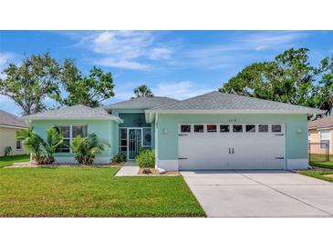 Charming single-story home with a well-manicured lawn, blue exterior paint and a two-car garage at 3718 61St E Dr, Bradenton, FL 34203