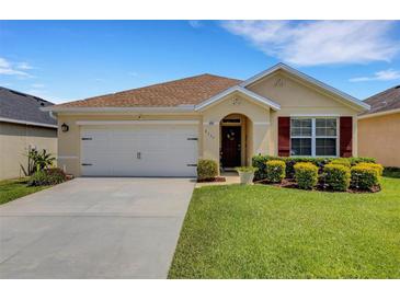 Charming single-story home featuring a well-maintained lawn and attached two-car garage at 5111 11Th E St, Bradenton, FL 34203