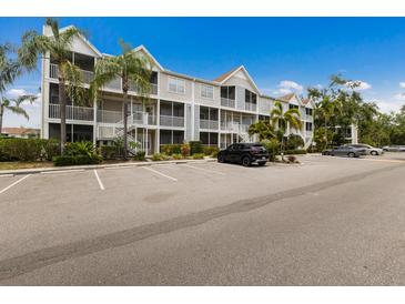 Well maintained condo complex with multiple units, landscaping, and ample parking at 850 S Tamiami Trl # 203, Sarasota, FL 34236