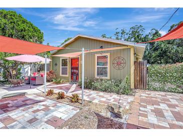 Charming home featuring a brick-paved patio and cozy seating area with colorful accents at 1489 18Th St, Sarasota, FL 34234