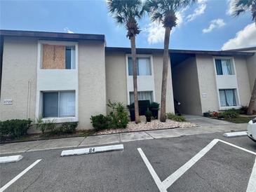 Multi-Gathering apartment building with parking, landscaping, and palm trees on a sunny day at 2733 Hidden Lake Blvd # A, Sarasota, FL 34237