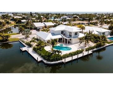 Stunning waterfront property with a private pool and dock, perfect for enjoying coastal living at 603 Emerald Ln, Holmes Beach, FL 34217