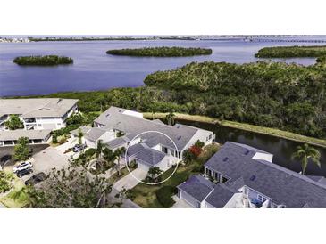 Stunning aerial view of a home near the water with lush greenery and beautiful landscaping at 1322 Perico Point Cir, Bradenton, FL 34209