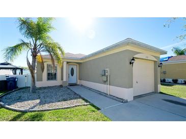 Charming single-story home featuring stucco siding, a one-car garage, a well-maintained lawn and mature landscaping at 2330 28Th E Ave, Palmetto, FL 34221