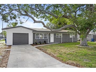 Charming single-story home with brick facade, attached garage, and mature shade tree at 3303 32Nd W St, Bradenton, FL 34205