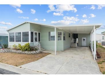 Charming single-story home with a covered carport and well-maintained landscaping, offering curb appeal at 3352 Laurel Oak Way, Sarasota, FL 34237