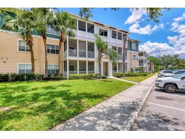 Beautiful condo building with well-maintained landscaping, beige walls, and white balconies at 4802 51St W St # 1711, Bradenton, FL 34210