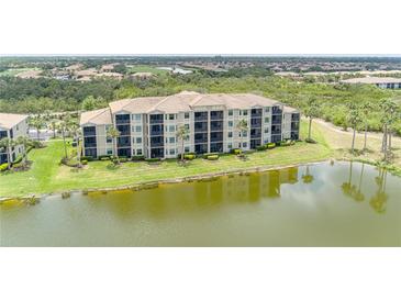 Beautiful condominium complex with lake views and lush landscaping at 7005 River Hammock Dr # 204, Bradenton, FL 34212