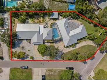 Aerial view of the property featuring a large lot, updated metal roof, and screened-in pool enclosure at 7202 18Th Nw Ave, Bradenton, FL 34209