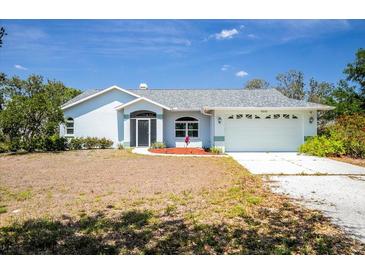 Charming single-story home with a well-manicured front yard and attached two-car garage at 10001 289Th E St, Myakka City, FL 34251