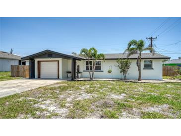 Charming single story home featuring well-maintained landscaping and attached garage at 1227 Porpoise Rd, Venice, FL 34293