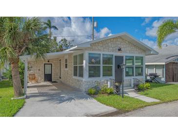 Charming stone house with a convenient carport and well-maintained landscaping, creating inviting curb appeal at 13 Oak St, Bradenton, FL 34208