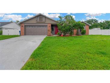 Charming single-Gathering home featuring a lush green lawn and a welcoming red front door at 2522 51St Street E Ct, Palmetto, FL 34221