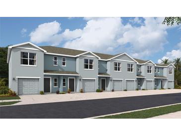 Charming townhome exterior featuring light blue paint, gray roof, attached garage, and well-manicured landscaping at 2755 Newbern Banks Dr, Bradenton, FL 34208