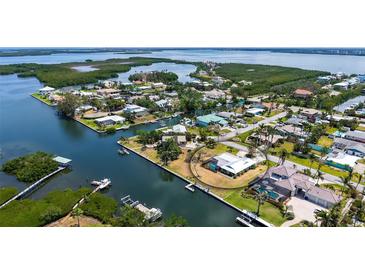 Waterfront home featuring direct boating access to the Gulf of Mexico, with lush tropical landscaping, and circular drive at 4361 Pompano Ln, Palmetto, FL 34221