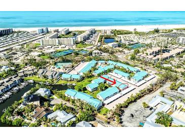 Breathtaking aerial view of the property's location with beach access and community amenities at 5669 Midnight Pass Rd # 308, Sarasota, FL 34242