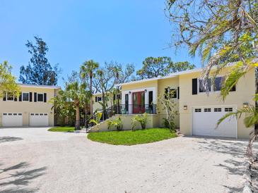 Charming home with meticulous landscaping, impact windows, and large driveway at 7320 Melaleuca Way, Siesta Key, FL 34242