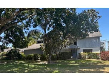Charming two-story home with landscaped yard and mature trees in a quiet residential neighborhood at 1212 Candlewood Dr, Lakeland, FL 33813