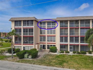 Beautful multifamily building with screened balconies and manicured landscaping at 4189 Heron Way # 406E, Bradenton, FL 34205