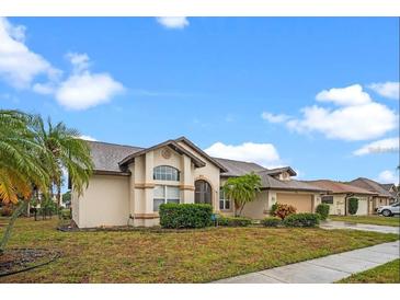 Charming single-story home featuring a stucco exterior, arched entry, and well-manicured landscaping at 4621 34Th E Ct, Bradenton, FL 34203
