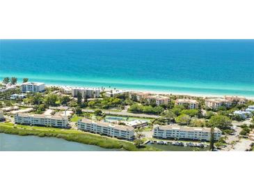 Beautiful aerial view of beachside condos and pristine blue ocean waters at 4840 Gulf Of Mexico Dr # Villa 15, Longboat Key, FL 34228