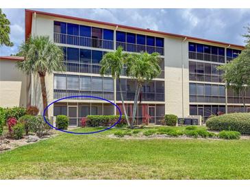 Condo building features a screened lanai, tropical landscaping, and multiple levels of resident balconies at 7500 40Th W Ave # 108, Bradenton, FL 34209