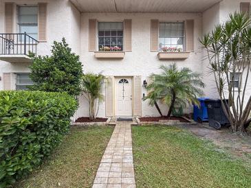 Charming front entrance with a welcoming walkway and well-maintained landscaping and decorative shutters at 11717 Wesson E Cir, Tampa, FL 33618