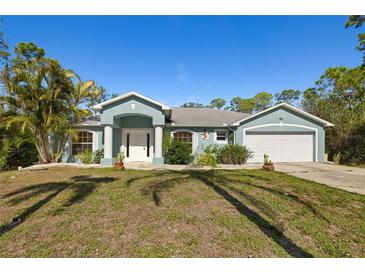 Charming single-story home with well-maintained landscaping, a two-car garage, and attractive curb appeal at 1399 Shields St, Punta Gorda, FL 33980