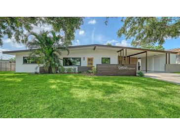 Charming single-story home with a well-manicured lawn and mature landscaping, offering inviting curb appeal at 2516 Goldenrod St, Sarasota, FL 34239