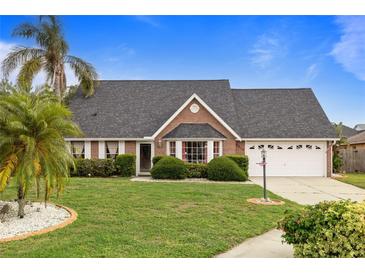 Charming single-Gathering home with a lush green lawn, mature palm trees, and a well-maintained exterior at 3910 77Th E Pl, Sarasota, FL 34243