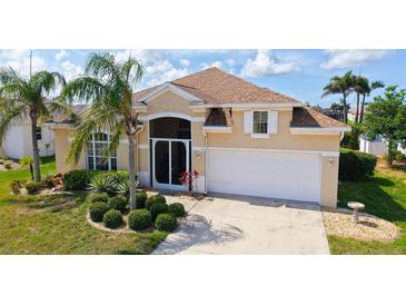 Charming single Gathering home boasts a lush landscaped yard and attached two car garage at 4274 Tennyson Way, Venice, FL 34293