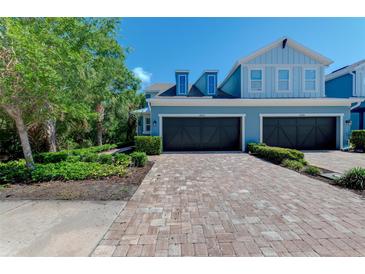 Charming two-story townhome with brick paver driveway and attached two-car garage at 4500 Chinkapin Dr, Sarasota, FL 34232
