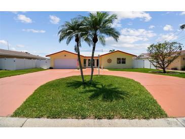 Charming single-story home with two palm trees and a circular driveway at 4829 Commonwealth Rd, Palmetto, FL 34221