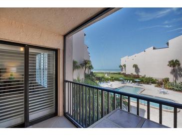 Relaxing balcony view overlooking the community pool and beach at 6480 Midnight Pass Rd # 311, Sarasota, FL 34242
