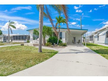 Charming single-story home with well-maintained lawn and tropical landscaping, perfect for relaxing in a sunny location at 714 N Waterway Dr, Venice, FL 34285