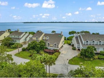 Stunning waterfront homes with lush landscaping and inviting curb appeal in a desirable community at 76 Tidy Island Blvd, Bradenton, FL 34210