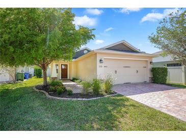 Charming single-Gathering home with a brick driveway, lush landscaping, and an attached two-car garage at 110 San Lorenzo Ct, Bradenton, FL 34208