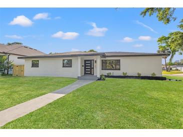 Charming single-story home with modern appeal, showcasing a well-manicured lawn and updated exterior at 1801 W Saint Isabel St, Tampa, FL 33607
