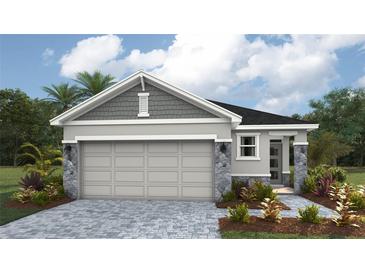 Charming single-Gathering home with a two-car garage and stone detailing at 1856 Cobb Trl, Parrish, FL 34219