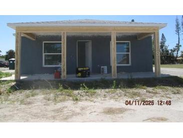 Newly constructed one-story home featuring a covered front porch and natural light from the windows at 2206 53Rd E Ave, Bradenton, FL 34203