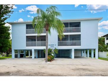 Coastal home featuring two stories, stilt construction, a well-manicured lawn and multiple screened-in balconies at 3703 5Th Ave # 3, Holmes Beach, FL 34217