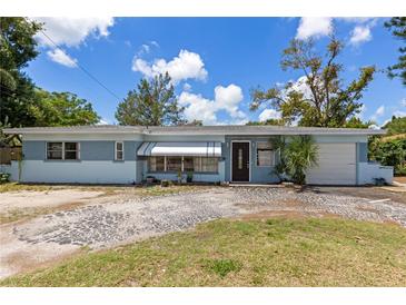 Charming single-story home with a light blue exterior, well-maintained lawn, and inviting curb appeal at 5916 Gulfport S Blvd, Gulfport, FL 33707