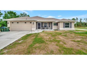 Charming single-story home with a two-car garage and screened front porch at 6104 Plamendon Ave, North Port, FL 34291