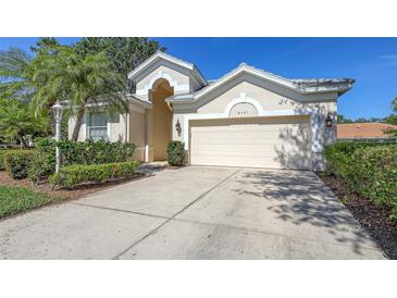 Charming home exterior with two car garage, lush landscaping, and a well maintained driveway at 6721 Oak Manor Dr, Lakewood Ranch, FL 34202