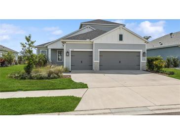 Charming home featuring a well-manicured lawn and a two-car garage, offering both curb appeal and practicality at 13708 Old Creek Ct, Parrish, FL 34219
