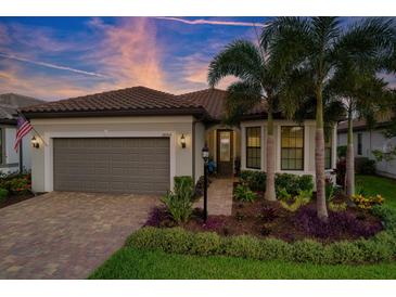 Charming single-story home with a two-car garage, lush landscaping, and beautiful paver driveway at 18008 Waterville Pl, Bradenton, FL 34202