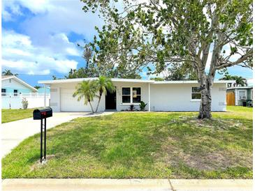 Charming single-story home with a well-maintained lawn, mature trees, and a welcoming front entrance at 1902 24Th W Ave, Bradenton, FL 34205