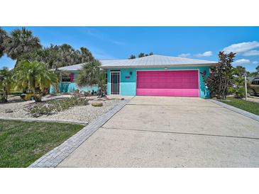 Charming single-story home with colorful exterior paint and a well-maintained front yard at 2127 Corfell St, Port Charlotte, FL 33948