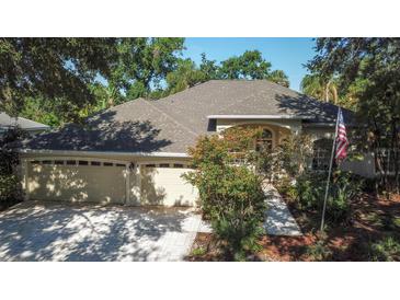 Attractive home with a three-car garage, lush landscaping, and a beautifully arched entryway at 2809 112Th E Ter, Parrish, FL 34219