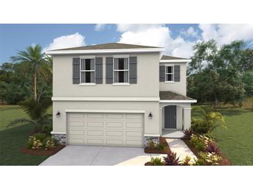 Charming two-story home with a two-car garage, stylish shutters, and a well-manicured lawn at 3210 Bitterroot Ln, Lakewood Ranch, FL 34211